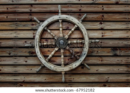 Steering wheel of the ship on a wooden wall of restaurant in marina of Tel-Aviv (Israel)