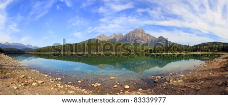 Reflection of mountains in smooth water of Pyramid lake (Jasper National Park, Alberta, Canada)