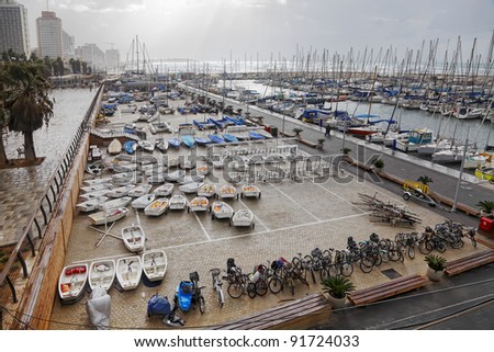 Storm by the Mediterranean sea and yachts in a marina