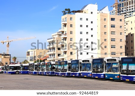 Bus parking on the background of the city and new buildings