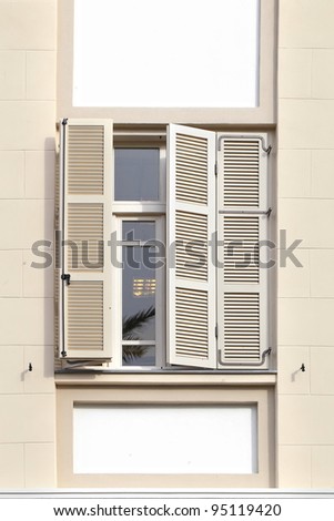 Window with shutters on an old reconstructed house