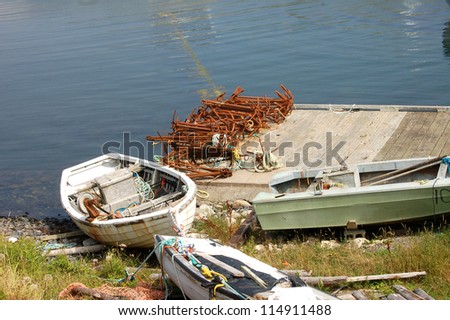 Boats and rusted anchors by the water