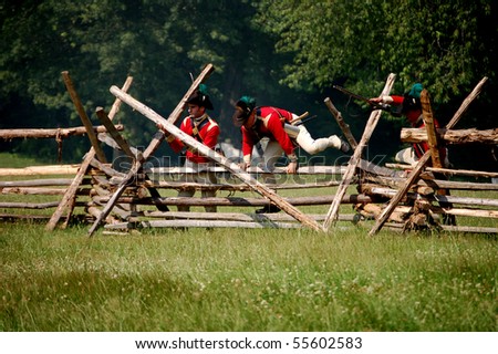 MANALAPAN, NJ - JUNE 19: British soldiers tear down a fence in order to advance their army on the battlefield at the 2010 re-enactment of the Battle of Monmouth on June 19, 2010 in Manalapan, NJ.