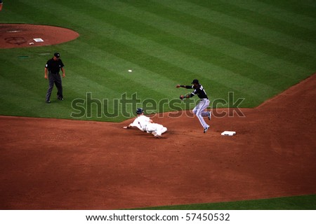 MINNEAPOLIS - JULY 17:  Alexi Ramirez of the White Sox jumps over Joe Mauer of the Twins to complete at double play in a game at Target Field July 17, 2010 in Minneapolis, MN.