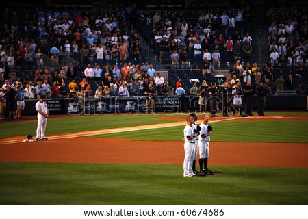 BRONX, NY - SEPTEMBER 7: Mark Teixeira, Nick Swisher, Curtis Granderson, Brett Gardner, Jorge Posada and the umpires stand at attention during the National Anthem on September 7, 2010 in Bronx, NY.