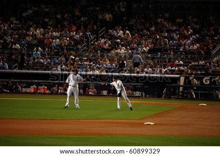 NEW YORK - SEPTEMBER 7: Yankees third baseman Ramiro Pena flips the ball back to pitcher C.C. Sabathia after recording an out against the Orioles at Yankee Stadium September 7, 2010 in New York, NY