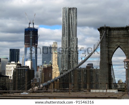 NEW YORK CITY - OCTOBER 21: Standing on the Brooklyn Bridge, one can view the skyline of Manhattan, including the new One WTC and New York by Gehry, shown here on October 21, 2011 in New York City