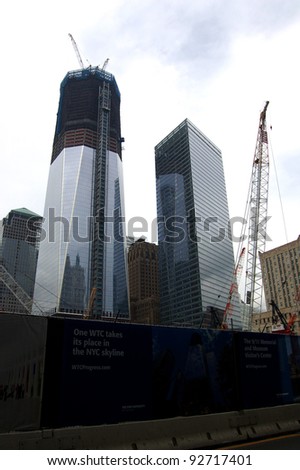 NEW YORK - SEPTEMBER 24: Workers continue to construct the new One World Trade Center (L) in New York Cityon September 24, 2011 next to 7 WTC, it is due to be completed in December 2012