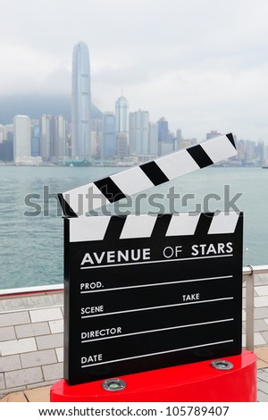 HONG KONG, CHINA - APR 17: Statue and skyline in Avenue of Stars on April 17, 2012 in Hong Kong, China. The promenade honors celebrities of the Hong Kong film industry as the famous city attraction.