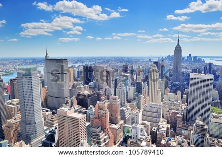 New York City Manhattan midtown aerial panorama view with skyscrapers and blue sky in the day.