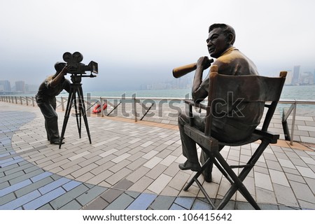 HONG KONG, CHINA - APR 17: Statue and skyline in Avenue of Stars on April 17, 2012 in Hong Kong, China. The promenade honours celebrities of the Hong Kong film industry as the famous city attraction.