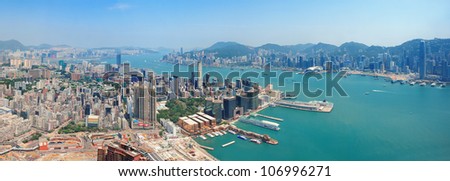 Hong Kong aerial view panorama with urban skyscrapers boat and sea.