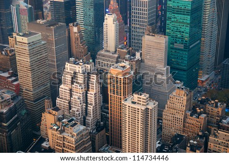 New York City Manhattan skyline aerial view with street and skyscrapers at sunset.
