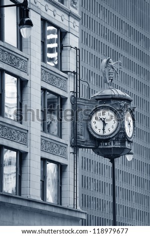 Chicago downtown street view with old fashion clock and skyscraper building in black and white.