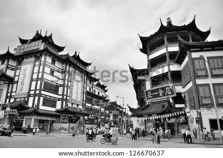 SHANGHAI, CHINA - MAY 30: Chenghuangmiao street with travelers and pagoda style buildings on May 30, 2012 in Shanghai. It is the largest city by population in the world with 23 million in 2010
