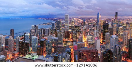 Chicago skyline panorama aerial view with skyscrapers over Lake Michigan with cloudy  sky at dusk.