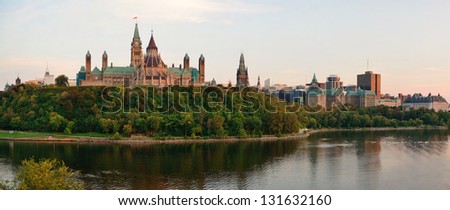 Ottawa sunset panorama over river with historical architecture.