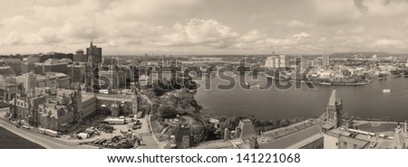 Ottawa cityscape panorama in the day over river with historical architecture black and white.