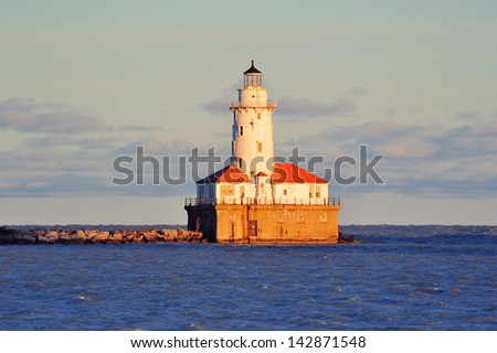 Chicago Light House in Lake Michigan with cloud and blue sky at sunset.
