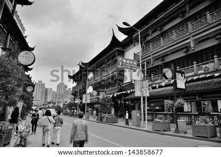 SHANGHAI, CHINA - MAY 30: Chenghuangmiao street with travelers and pagoda style buildings on May 30, 2012 in Shanghai. It is the largest city by population in the world with 23 million in 2010