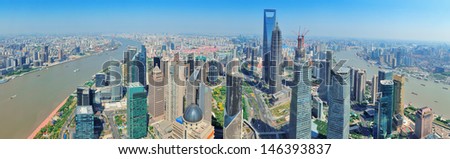 Shanghai city aerial view panorama with urban architecture over river and blue sky in the day.