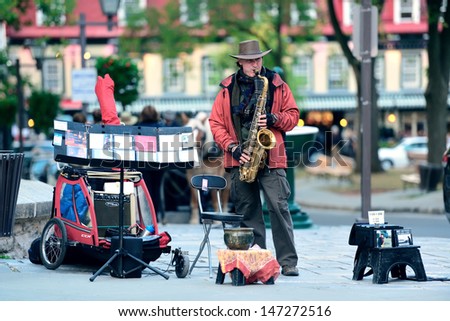 QUEBEC CITY, CANADA - SEP 10: Local artist performs on street on September 10, 2012 in Quebec City, Canada. As the capital of the Quebec, it is one of the oldest cities in North America.