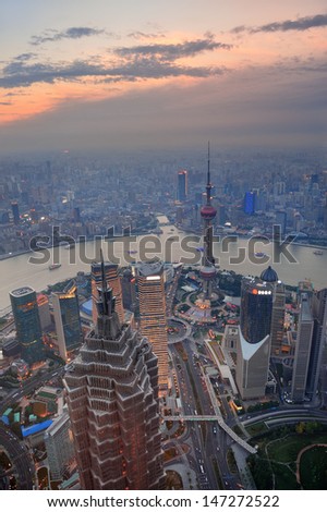 Shanghai aerial view at sunset with urban skyscrapers over river