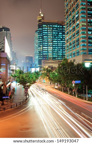 Shanghai street view with urban scene and busy traffic at dusk.