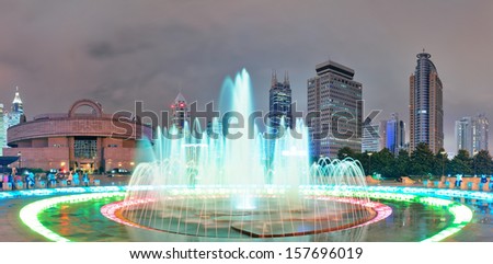 Shanghai People's Square with fountain and urban skyline at night panorama