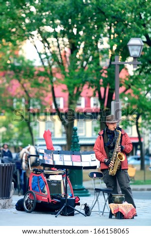 QUEBEC CITY, CANADA - SEP 10: Local artist performs on street on September 10, 2012 in Quebec City, Canada. As the capital of the Quebec, it is one of the oldest cities in North America.
