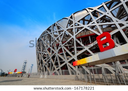BEIJING, CHINA - APR 7: Beijing National Stadium with blue sky on April 7, 2013 in Beijing, China. The stadium was established for the 2008 Summer Olympics and Paralympics.