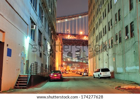 Brooklyn street view at night with New York City Manhattan downtown skyline.