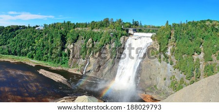 Montmorency Falls panorama with rainbow and blue sky near Quebec City.