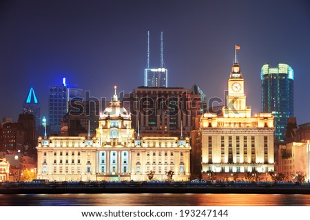 Shanghai historic architecture at night lit by lights over Huangpu River