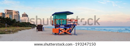 Miami Beach sunset panorama with lifeguard tower and hotels.