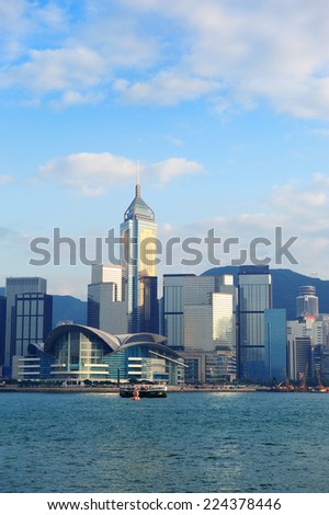 Urban architecture in Hong Kong Victoria Harbor in the day with blue sky, boat and cloud.
