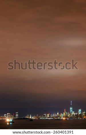New York City at night with urban architectures and cloudy sky