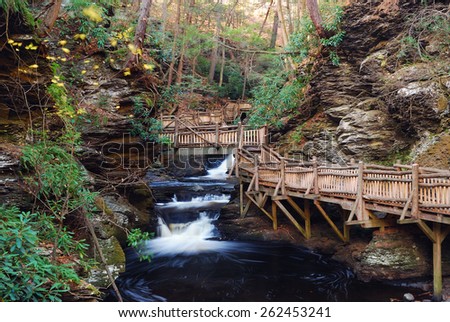 Autumn creek with hiking trails and foliage in forest. From Bushkill Falls, Pennsylvania.
