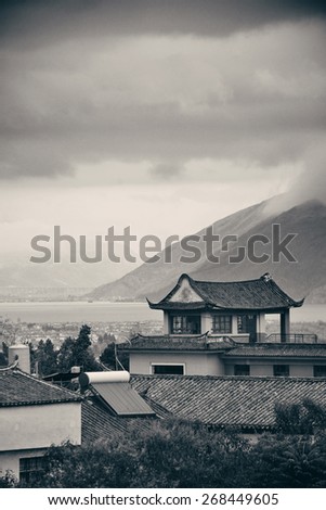 Dali Old Town with misty mountain and historical buildings in Yunnan, China.