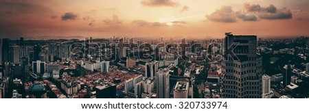 Singapore rooftop view with urban skyscrapers at sunset.