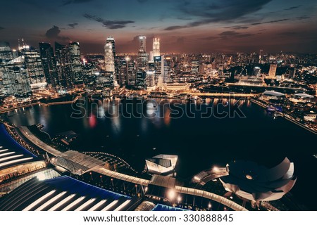 Singapore Marina Bay rooftop view with urban skyscrapers at night.
