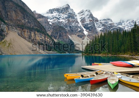 Moraine Lake and boat with snow capped mountain of Banff National Park in Canada