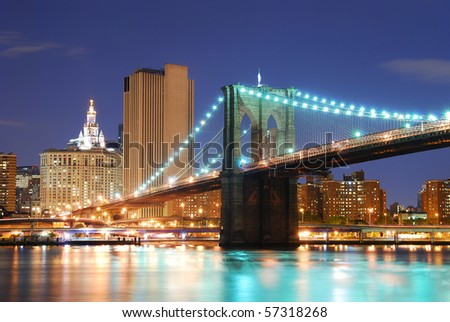New York City Manhattan skyline and Brooklyn Bridge at dusk over Hudson River with skyscrapers