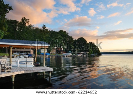 Lake house with pier and woods with sunrise in the morning in New York state Finger Lakes