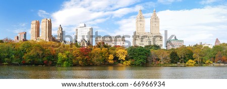 New York City Manhattan Central Park panorama in Autumn lake with skyscrapers and colorful trees over with reflection.