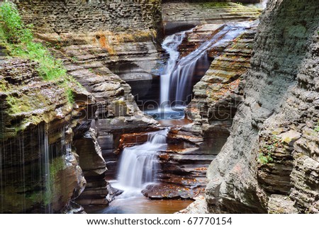 Watkins Glen waterfall in woods with rocks and stream in Watkins Glen state park in New York State
