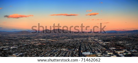 Las Vegas City Skyline panorama with sunset, mountain, luxury hotels and streets.