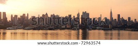 Manhattan urban skyline panorama in New York City with Empire State Building at sunrise over Hudson River