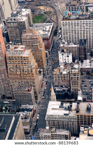 New York City Manhattan street aerial view with skyscrapers, pedestrian and busy traffic.