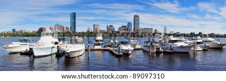 Boston Charles River panorama with urban city skyline skyscrapers and boats with blue sky over Charles River.